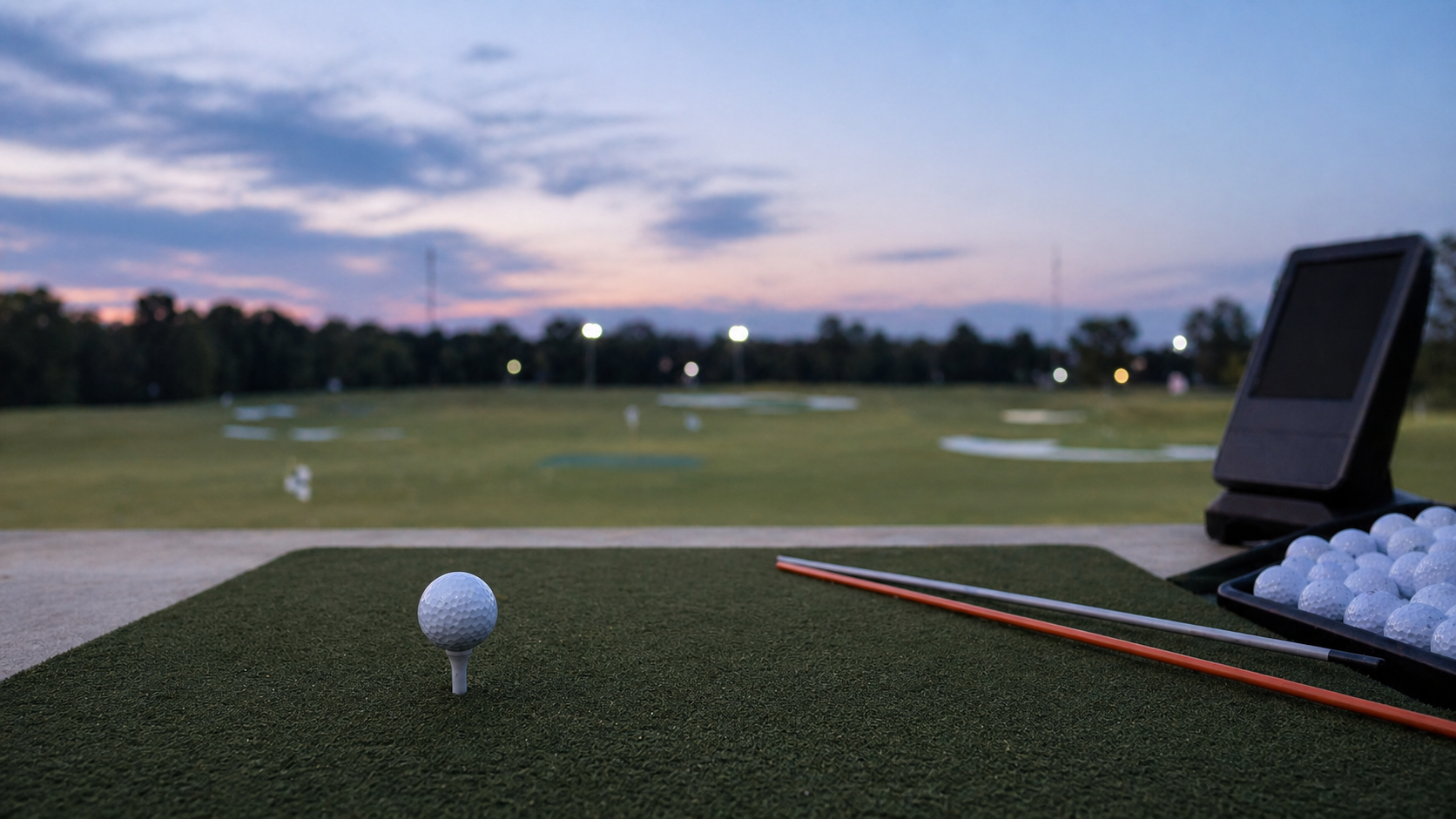 Unbranded golf ball on a tee at a driving range